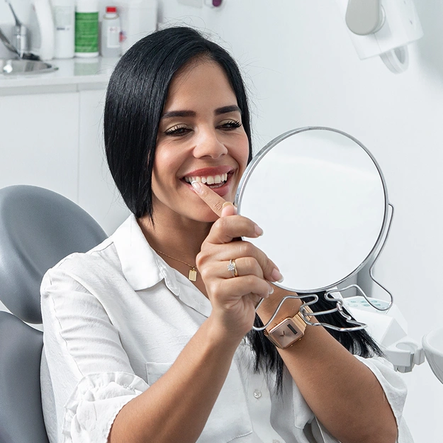 Woman smiling and looking at mirror